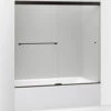 Kohler K-707002-L-ABZ Revel Sliding Bath Door, 62 In H X 56-5/8 - 59-5/8 In W, With 5/16 In Thick Crystal Clear Glass - Brushed Bronze